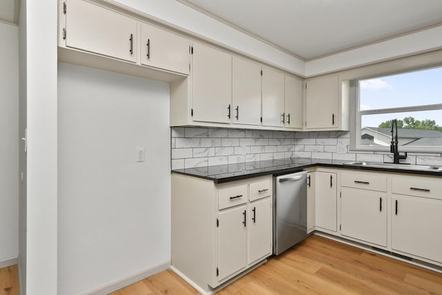 2658 S Hillsboro, Springfield, MO 65802 - kitchen with a sink, stainless steel dishwasher, dark countertops, backsplash, and light wood-style flooring