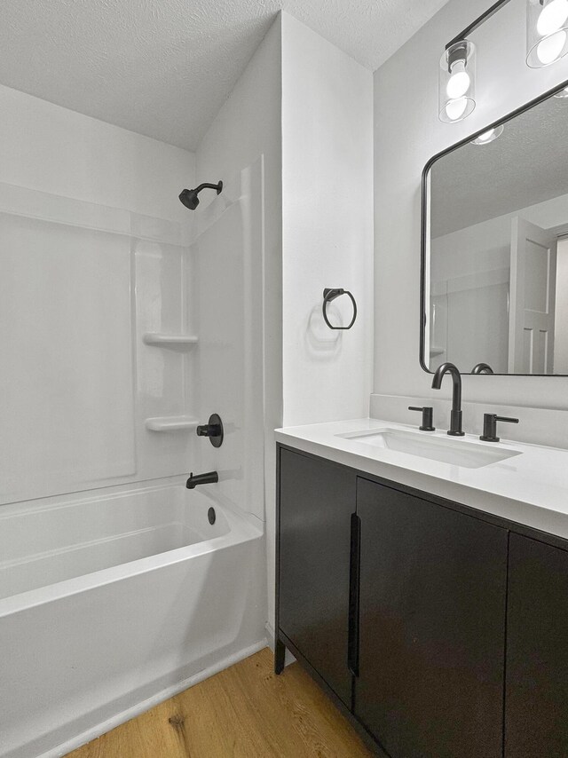 2658 S Hillsboro, Springfield, MO 65802 - bathroom with wood finished floors, shower / tub combination, vanity, and a textured ceiling
