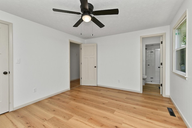 2658 S Hillsboro, Springfield, MO 65802 - unfurnished bedroom featuring light wood finished floors, ensuite bath, baseboards, and a textured ceiling