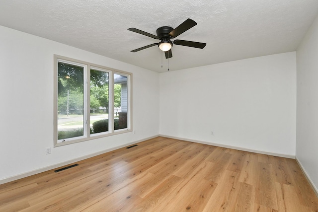 2658 S Hillsboro, Springfield, MO 65802 - empty room featuring wood finished floors, baseboards, ceiling fan, and a textured ceiling