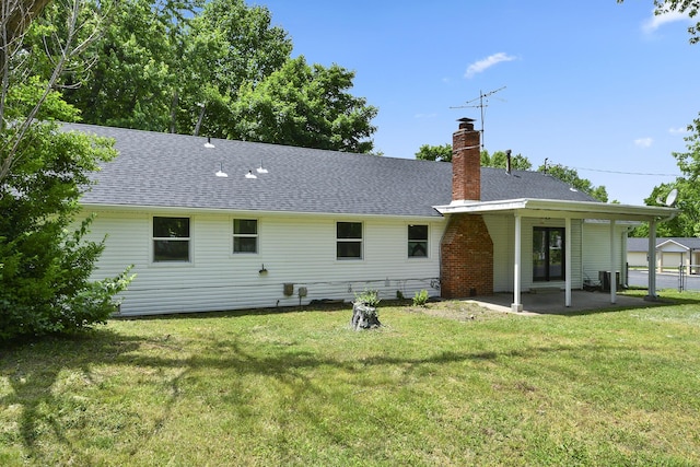 2658 S Hillsboro, Springfield, MO 65802 - rear view of house with a chimney, a patio, a lawn, and a shingled roof