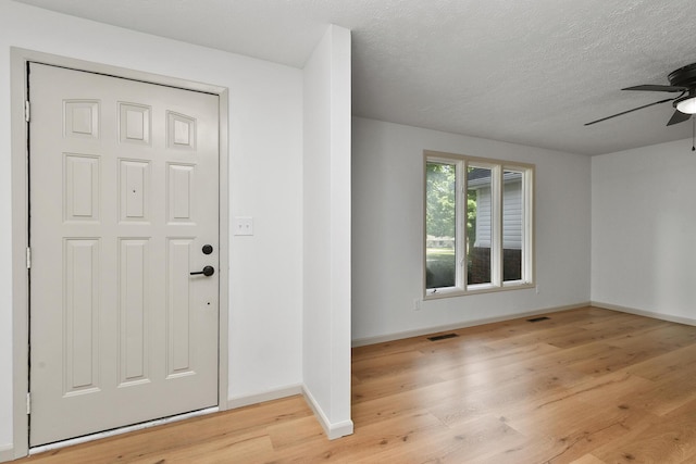 2658 S Hillsboro, Springfield, MO 65802 - foyer entrance with a ceiling fan, baseboards, light wood-style floors, and a textured ceiling
