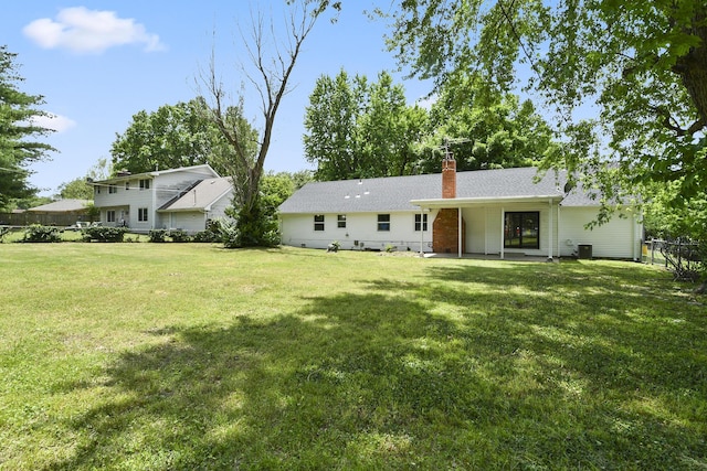 2658 S Hillsboro, Springfield, MO 65802 - rear view of property with a chimney and central air condition unit