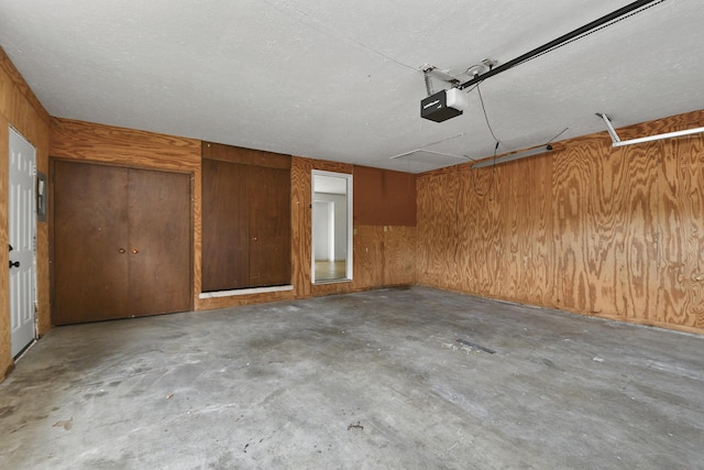 2658 S Hillsboro, Springfield, MO 65802 - garage featuring a garage door opener and wood walls