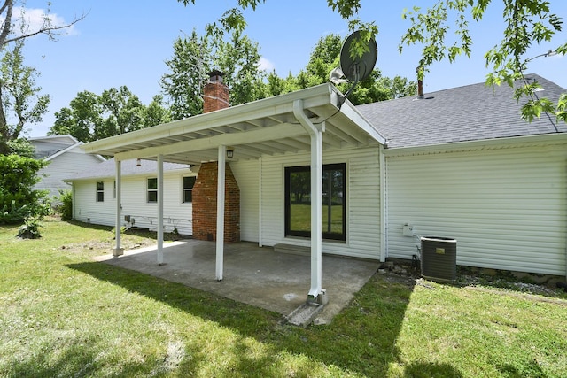 2658 S Hillsboro, Springfield, MO 65802 - back of house featuring a yard, roof with shingles, central AC, a chimney, and a patio area