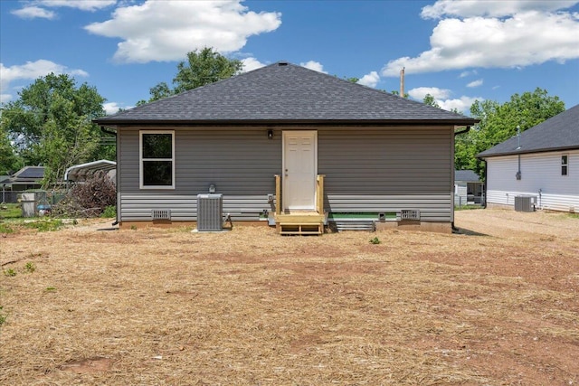 1052 S Overhill Ave, Springfield, MO 65802 - back of property featuring central AC, a shingled roof, and crawl space