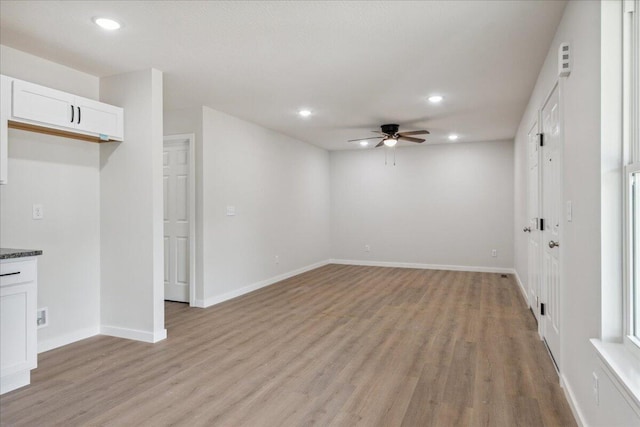 1052 S Overhill Ave, Springfield, MO 65802 - unfurnished living room featuring ceiling fan, recessed lighting, light wood-style flooring, and baseboards