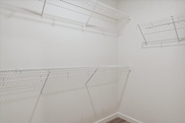 1052 S Overhill Ave, Springfield, MO 65802 - walk in closet featuring wood finished floors