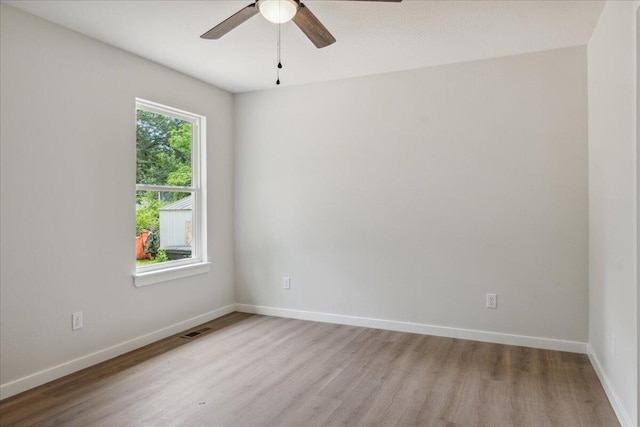 1052 S Overhill Ave, Springfield, MO 65802 - spare room featuring light wood-type flooring, a ceiling fan, and baseboards
