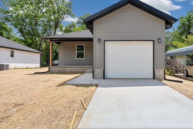 1052 S Overhill Ave, Springfield, MO 65802 - view of front of house with concrete driveway, central AC, and a garage