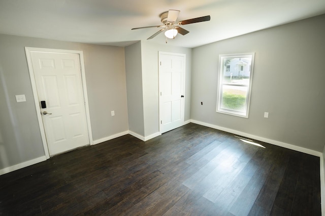 1443 6th St, West Plains, MO 65775 - unfurnished bedroom featuring baseboards, dark wood-type flooring, and a ceiling fan