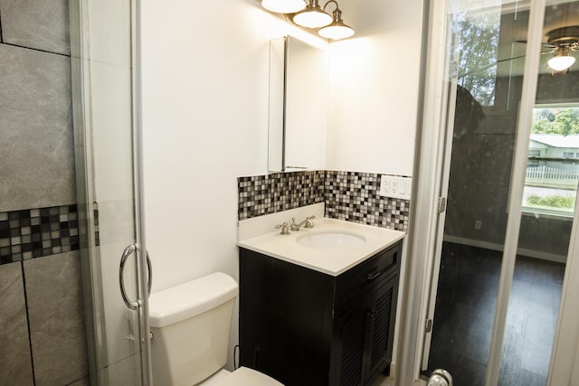 1443 6th St, West Plains, MO 65775 - bathroom with vanity, toilet, and decorative backsplash