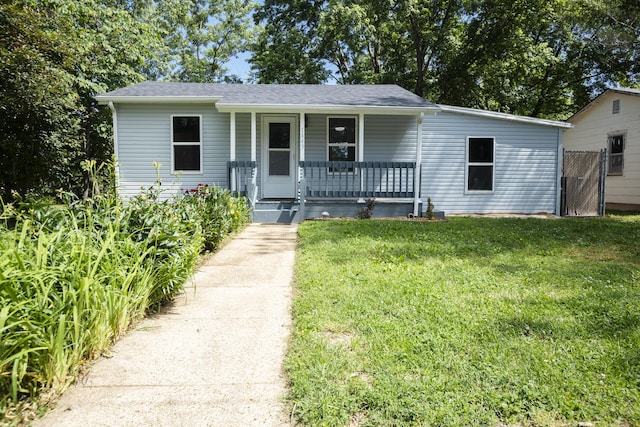 1443 6th St, West Plains, MO 65775 - bungalow-style home with a porch, a front yard, and a shingled roof