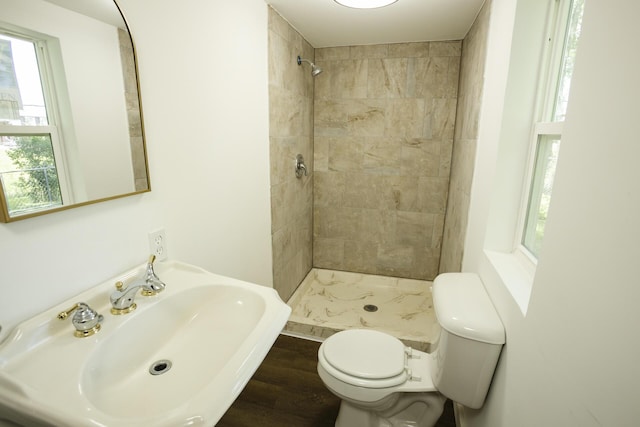 1443 6th St, West Plains, MO 65775 - full bathroom with toilet, a sink, a tile shower, and healthy amount of natural light