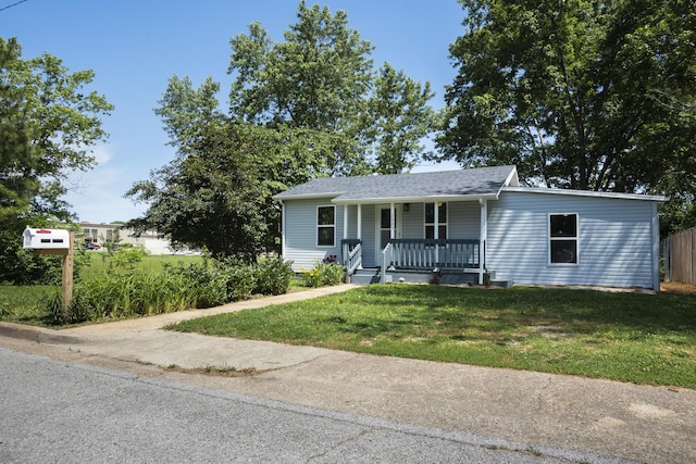 1443 6th St, West Plains, MO 65775 - view of front of home featuring covered porch, a front yard, and a shingled roof