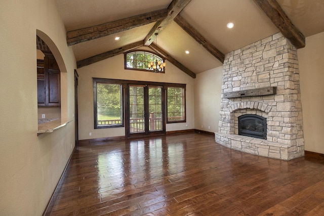 184 Appaloosa Trl, Saddlebrooke, MO 65630 - unfurnished living room with hardwood / wood-style flooring, a fireplace, baseboards, arched walkways, and french doors