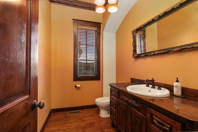 184 Appaloosa Trl, Saddlebrooke, MO 65630 - bathroom featuring vanity, wood finished floors, toilet, baseboards, and a chandelier