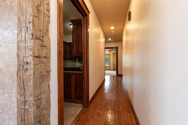 184 Appaloosa Trl, Saddlebrooke, MO 65630 - hallway with wood-type flooring and baseboards