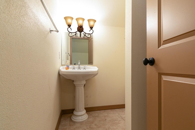 184 Appaloosa Trl, Saddlebrooke, MO 65630 - bathroom with tile patterned flooring, a chandelier, and baseboards