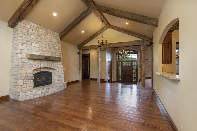 184 Appaloosa Trl, Saddlebrooke, MO 65630 - unfurnished living room with beamed ceiling, a chandelier, hardwood / wood-style flooring, baseboards, and a stone fireplace