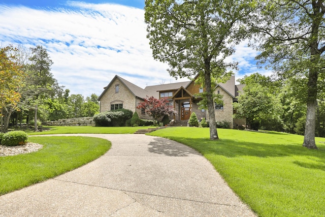 184 Appaloosa Trl, Saddlebrooke, MO 65630 - view of front facade with a front yard, stone siding, and brick siding