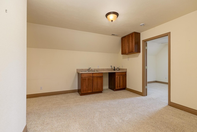 184 Appaloosa Trl, Saddlebrooke, MO 65630 - kitchen with brown cabinetry, light colored carpet, a sink, baseboards, and light countertops