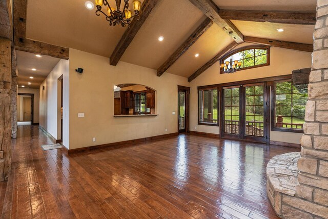 184 Appaloosa Trl, Saddlebrooke, MO 65630 - unfurnished living room featuring a chandelier, hardwood / wood-style flooring, beamed ceiling, baseboards, and high vaulted ceiling