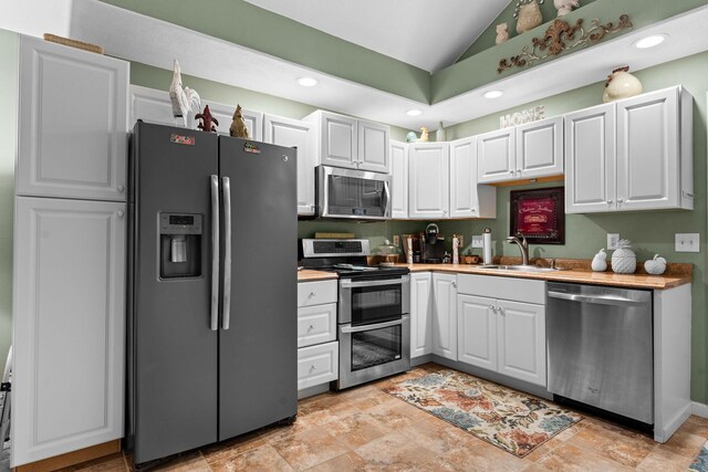 180 Grace Chapel Rd, Blue Eye, MO 65611 - kitchen featuring appliances with stainless steel finishes, a sink, vaulted ceiling, recessed lighting, and light countertops