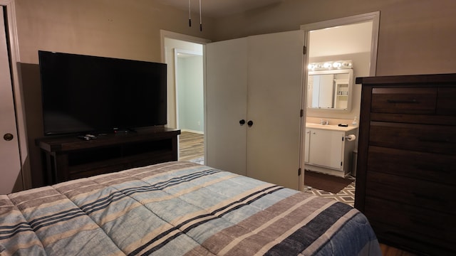 606 W Clover Dr, Clinton, MO 64735 - bedroom with ensuite bath and wood finished floors