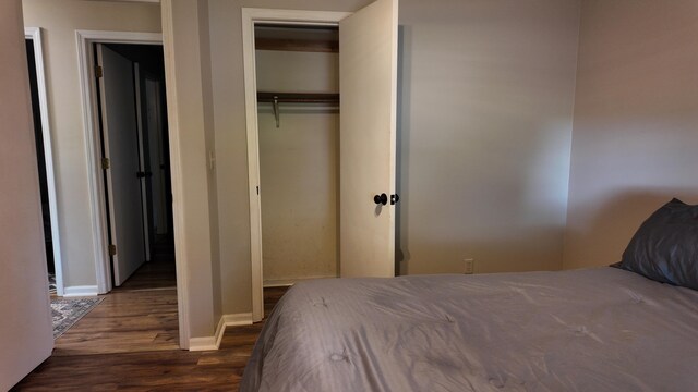 606 W Clover Dr, Clinton, MO 64735 - bedroom with wood finished floors, baseboards, and a closet