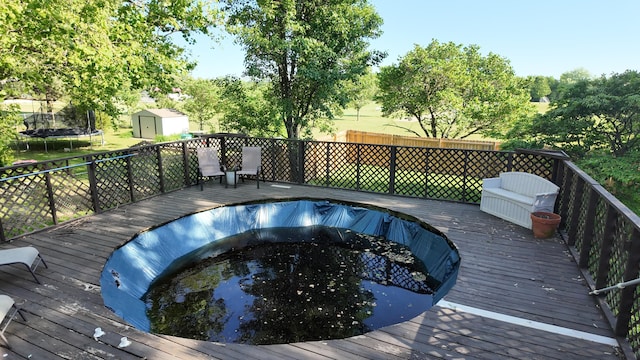 606 W Clover Dr, Clinton, MO 64735 - wooden deck featuring a trampoline