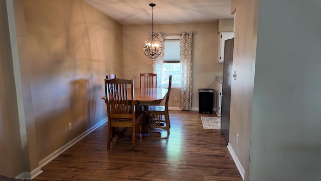 606 W Clover Dr, Clinton, MO 64735 - dining space featuring a chandelier, dark wood-type flooring, and baseboards