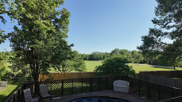 606 W Clover Dr, Clinton, MO 64735 - view of swimming pool featuring a wooden deck, view of golf course, and view of wooded area