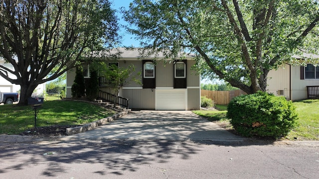 606 W Clover Dr, Clinton, MO 64735 - view of front of property featuring a garage, concrete driveway, and stairway