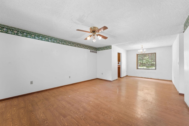 111-141 Gooseberry Ct, Branson, MO 65616 - unfurnished room featuring a chandelier, a textured ceiling, a ceiling fan, light wood finished floors, and baseboards