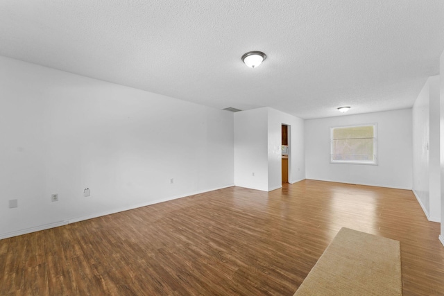 111-141 Gooseberry Ct, Branson, MO 65616 - spare room featuring wood finished floors, a textured ceiling, and baseboards