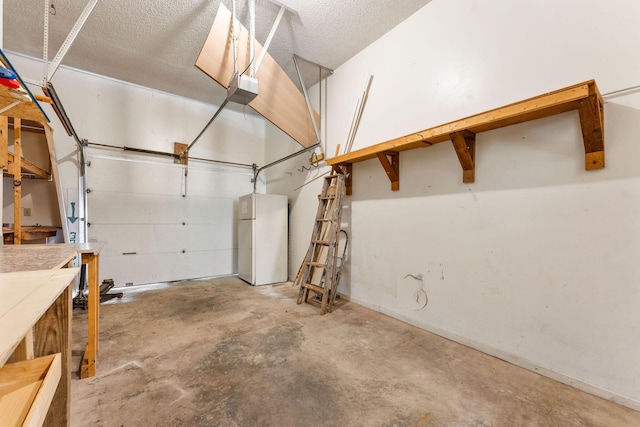 111-141 Gooseberry Ct, Branson, MO 65616 - garage featuring freestanding refrigerator, a garage door opener, and baseboards