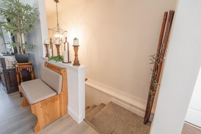 205 Seigenbein Rd, Saint Robert, MO 65584 - stairway featuring wood finished floors, a chandelier, and baseboards