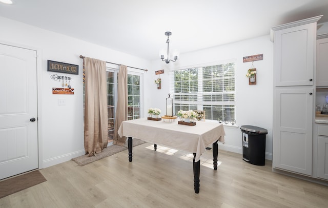 205 Seigenbein Rd, Saint Robert, MO 65584 - dining room with a chandelier, light wood-style flooring, and baseboards