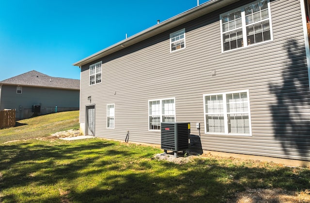 205 Seigenbein Rd, Saint Robert, MO 65584 - rear view of house featuring central AC unit and a yard