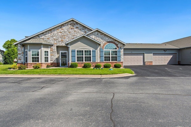 208 Rue De Villas Cir Unit 4, Branson, MO 65616 - view of front of house with asphalt driveway, a garage, brick siding, a front lawn, and stone siding