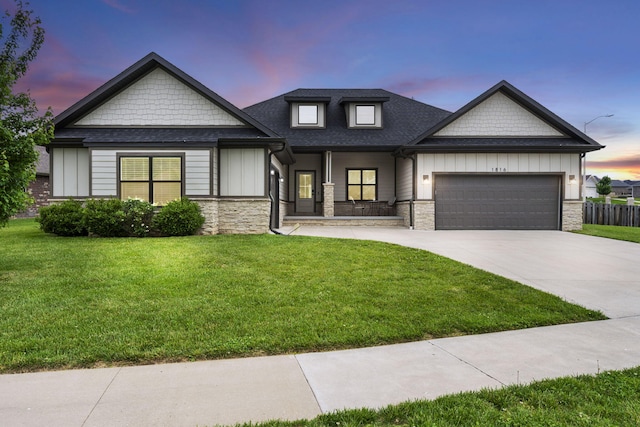 1816 N Bristol Ave, Springfield, MO 65802 - view of front of home with stone siding, an attached garage, concrete driveway, board and batten siding, and a porch