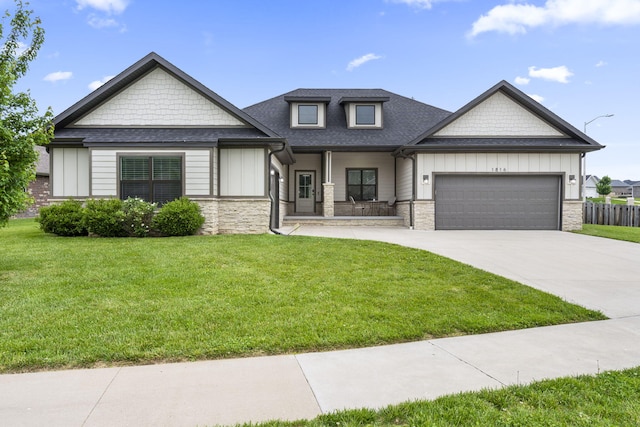 1816 N Bristol Ave, Springfield, MO 65802 - view of front of house with an attached garage, driveway, a porch, stone siding, and board and batten siding