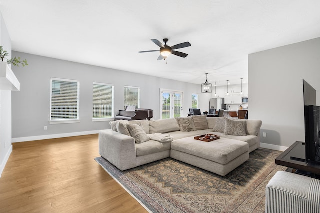 1816 N Bristol Ave, Springfield, MO 65802 - living room with a ceiling fan, baseboards, and light wood-type flooring