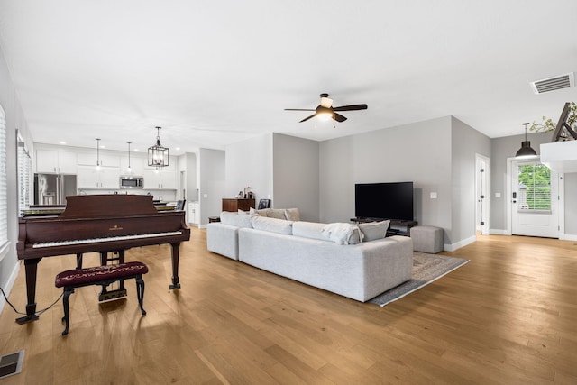 1816 N Bristol Ave, Springfield, MO 65802 - living area featuring light wood finished floors, a ceiling fan, baseboards, and recessed lighting