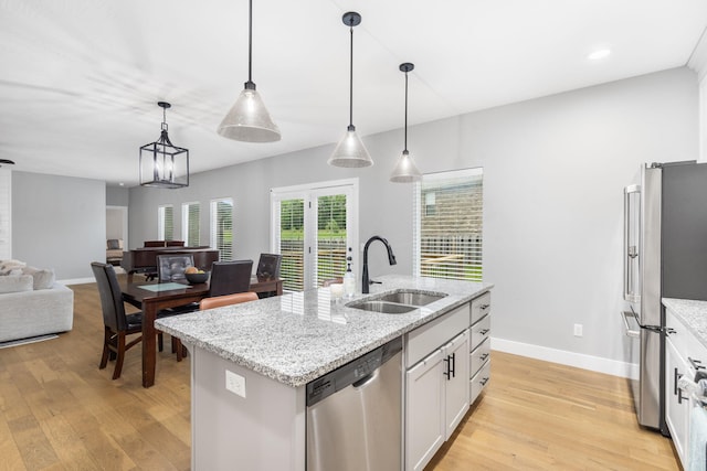 1816 N Bristol Ave, Springfield, MO 65802 - kitchen with stainless steel appliances, a sink, light wood-style flooring, and open floor plan