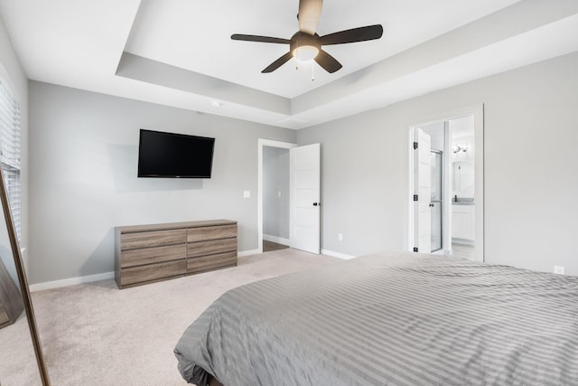 1816 N Bristol Ave, Springfield, MO 65802 - carpeted bedroom featuring baseboards, a raised ceiling, connected bathroom, and ceiling fan