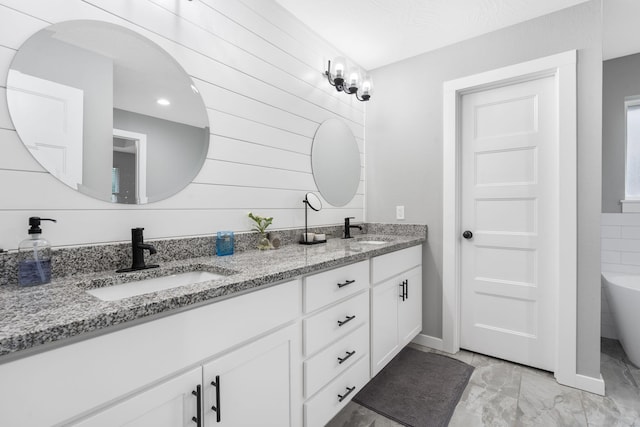 1816 N Bristol Ave, Springfield, MO 65802 - bathroom featuring marble finish floors, double vanity, and a freestanding bath