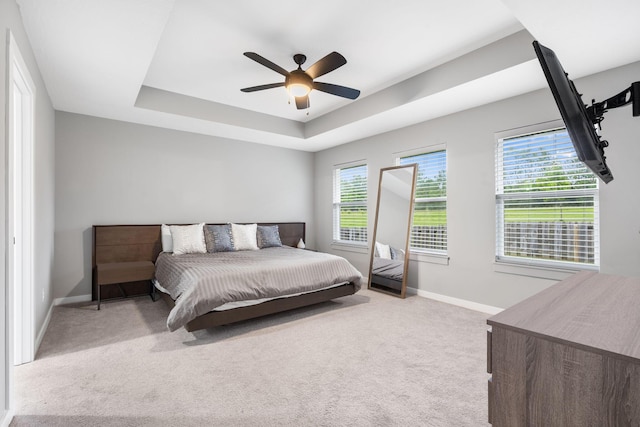 1816 N Bristol Ave, Springfield, MO 65802 - bedroom featuring light carpet, baseboards, a tray ceiling, and a ceiling fan