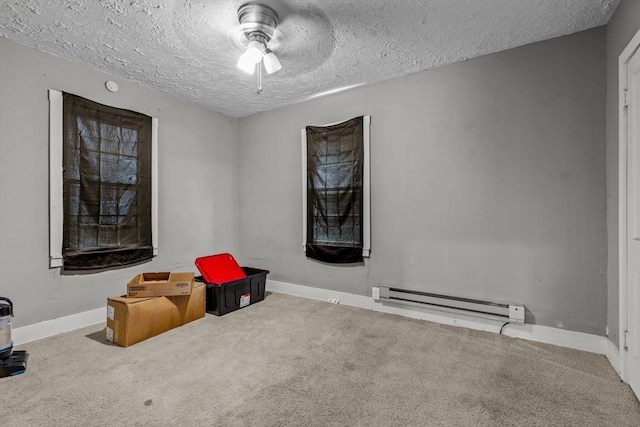 524 W Mckown St, Buffalo, MO 65622 - unfurnished room featuring a baseboard heating unit, ceiling fan, carpet floors, a textured ceiling, and baseboards